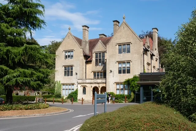 The Bath Clinic, a gabled Bath stone manor house set among mature trees.